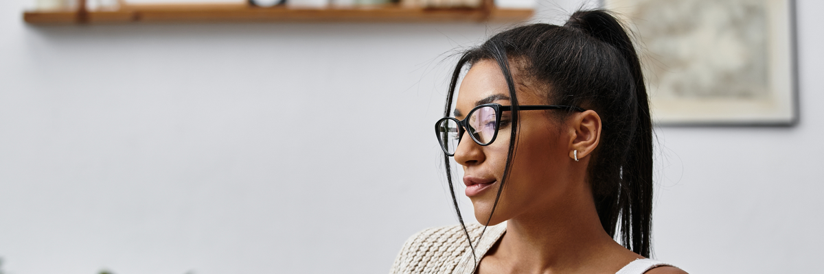 A beautiful young woman is engaged in remote learning, tapping away on her laptop at home.