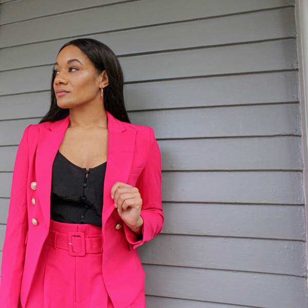 A stylish business suit displayed on a rack, symbolizing empowerment and modern power dressing