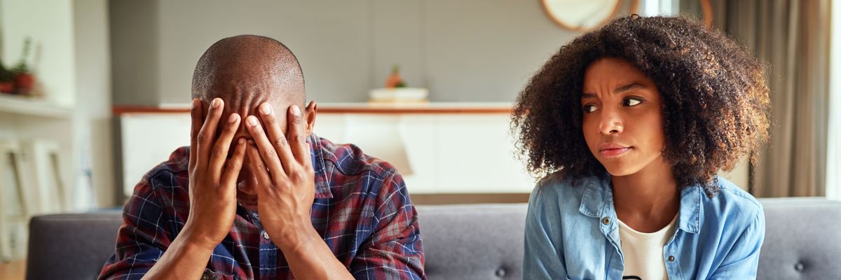 Apartment, couple and arguing in living room on couch for disagreement, problems and unhappy. Relationship, people and conflict or upset with confrontation at lounge on sofa with regret and toxic