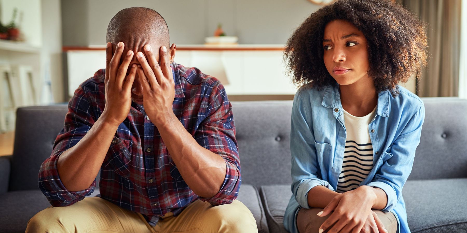 Apartment, couple and arguing in living room on couch for disagreement, problems and unhappy. Relationship, people and conflict or upset with confrontation at lounge on sofa with regret and toxic