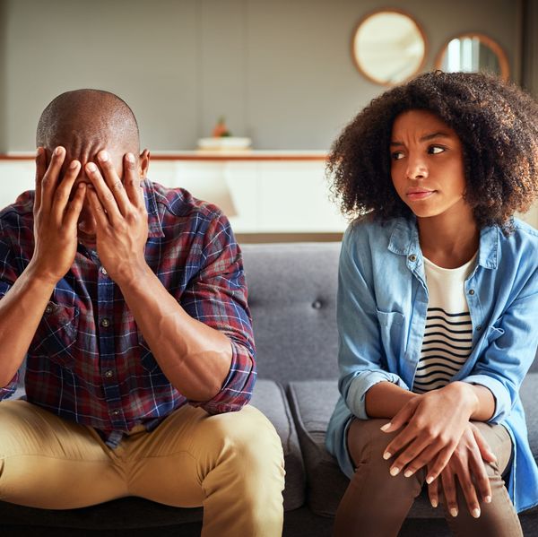 Apartment, couple and arguing in living room on couch for disagreement, problems and unhappy. Relationship, people and conflict or upset with confrontation at lounge on sofa with regret and toxic