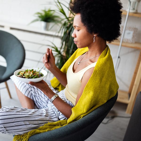 Beautiful woman eating healthy fresh organic salad