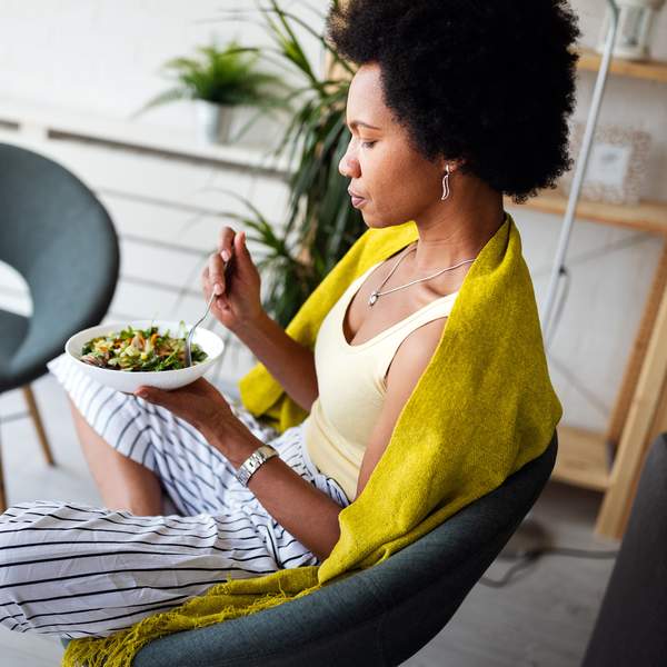 Beautiful woman eating healthy fresh organic salad