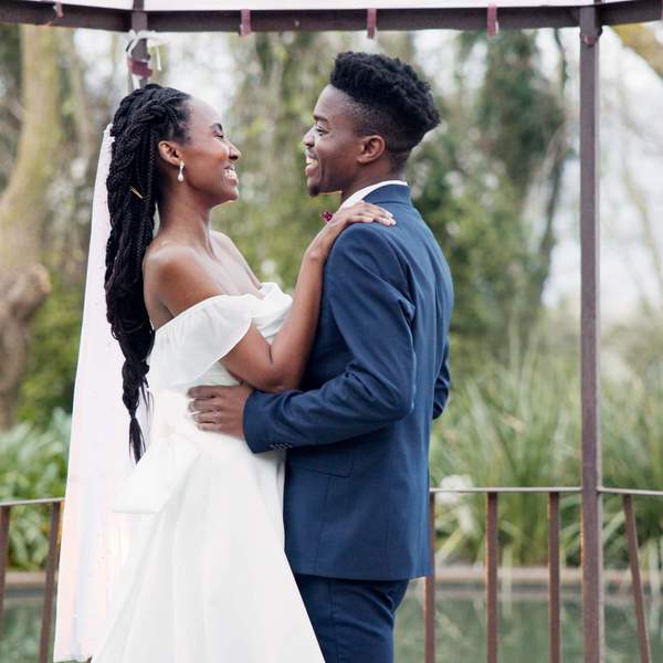 Black-couple-embracing-lovingly-under-gazebo-micro-wedding-intimate-wedding-moment