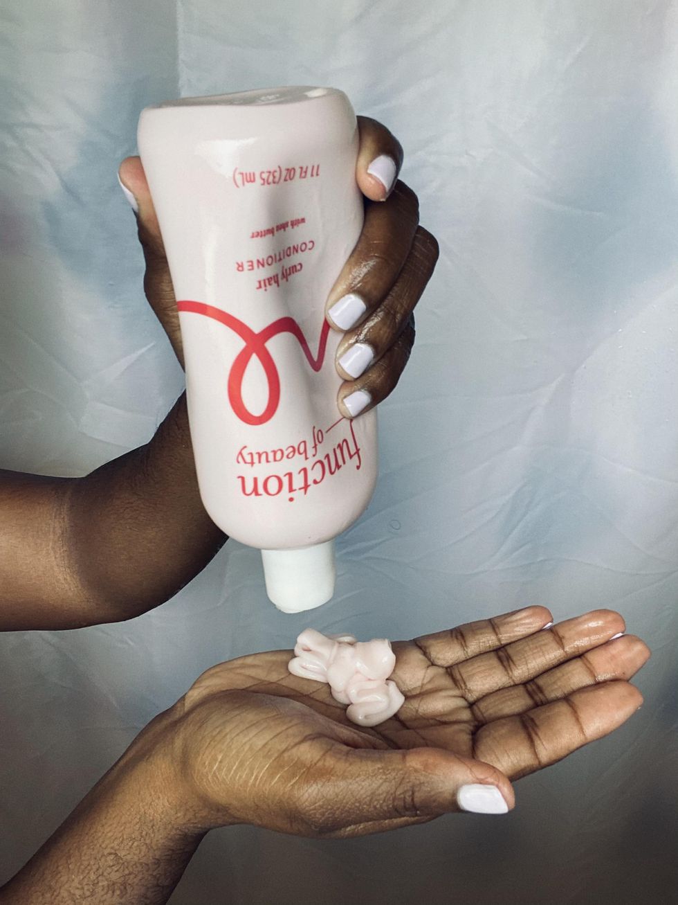 black girl-pouring-conditioner-into-her-hands