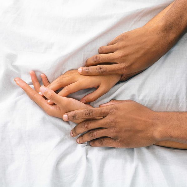 Black man and woman enjoying sexual foreplay in bed, free space