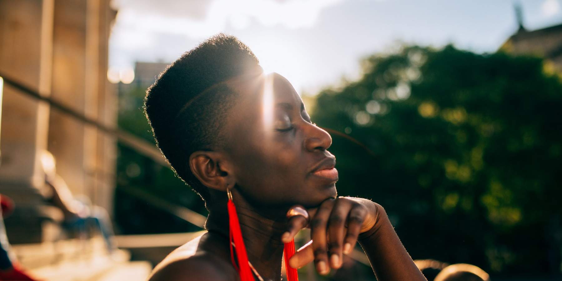 Black-woman-basking-in-light-of-the-sun-letting-go