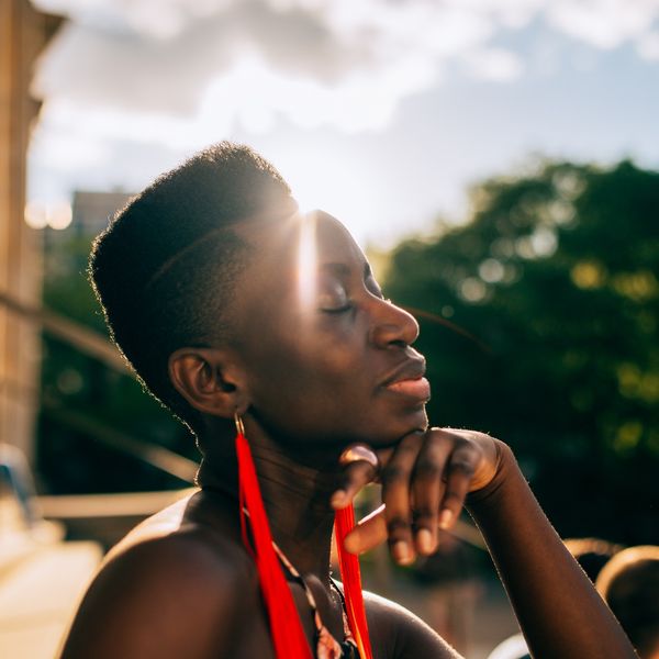 Black-woman-basking-in-light-of-the-sun-letting-go
