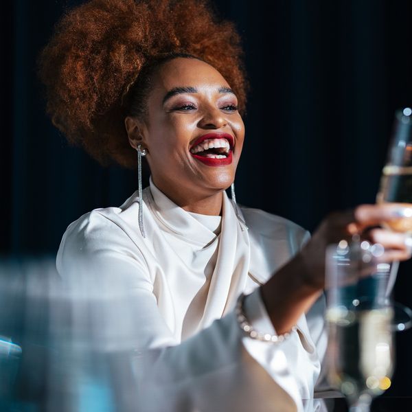 Black woman celebrating with champagne