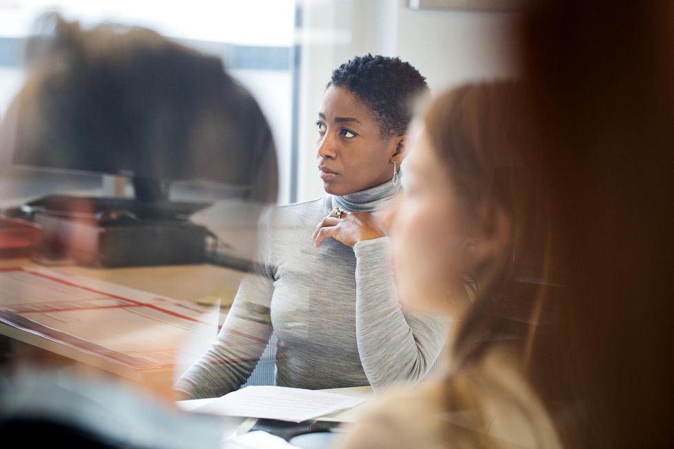Black woman concerned at work meeting