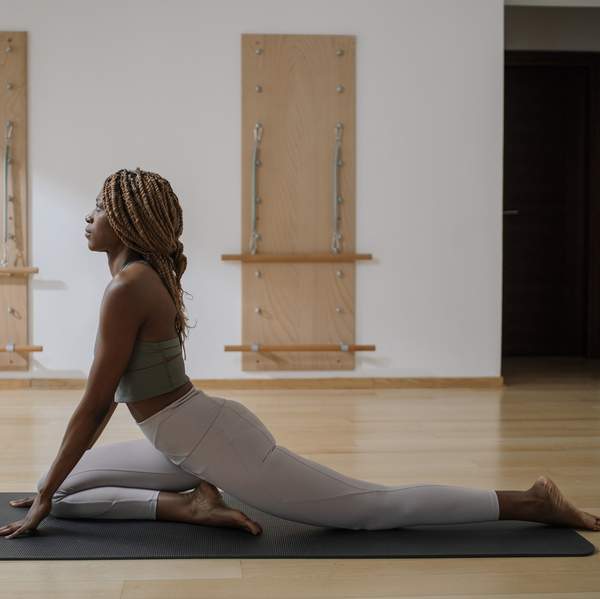 Black-woman-in-exercise-clothes-doing-Pilates-beginner