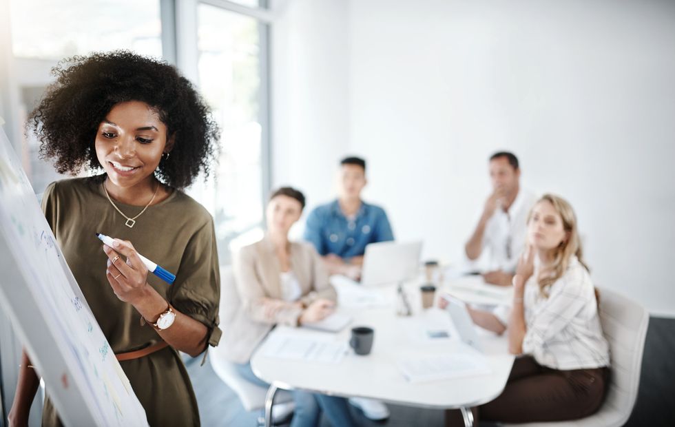 Black woman leading work meeting