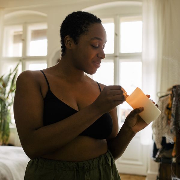 Black-woman-lighting-a-candle-in-her-apartment