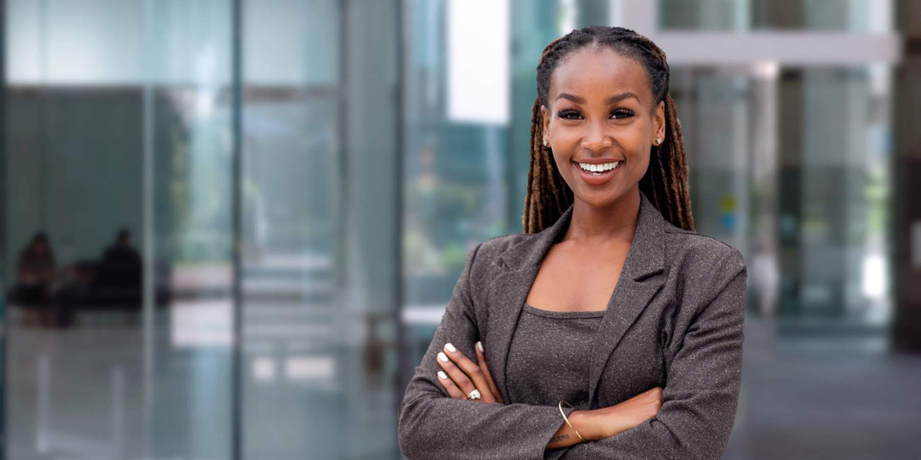 black-woman-locs-crossed-arms-professional-smiling