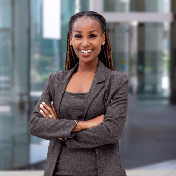 black-woman-locs-crossed-arms-professional-smiling