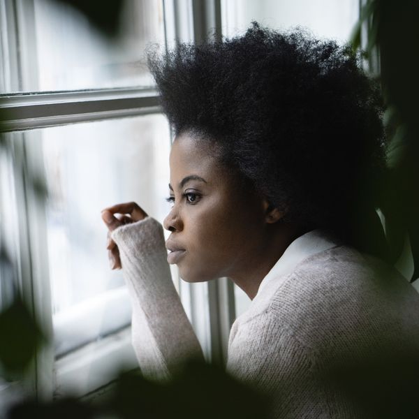 Black-woman-looking-out-of-her-window-searching-for-something-purpose