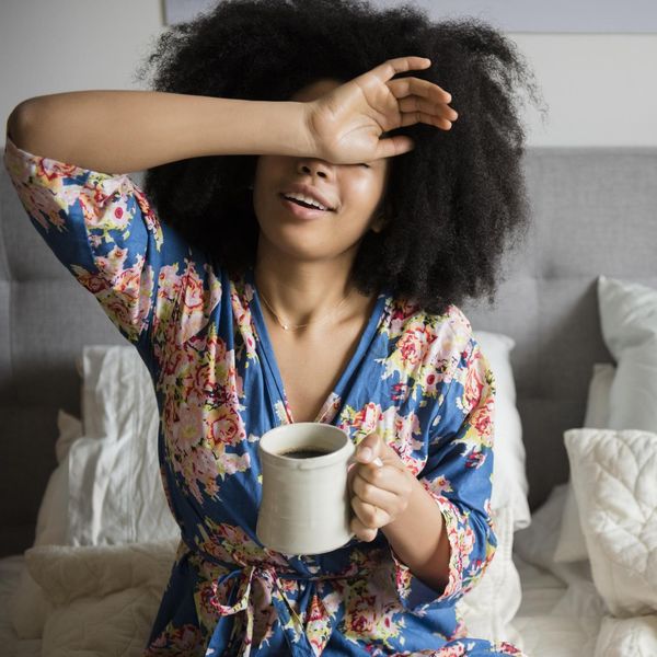 Black-woman-rising-early-stretching-in-the-morning-with-tea-in-her-hand