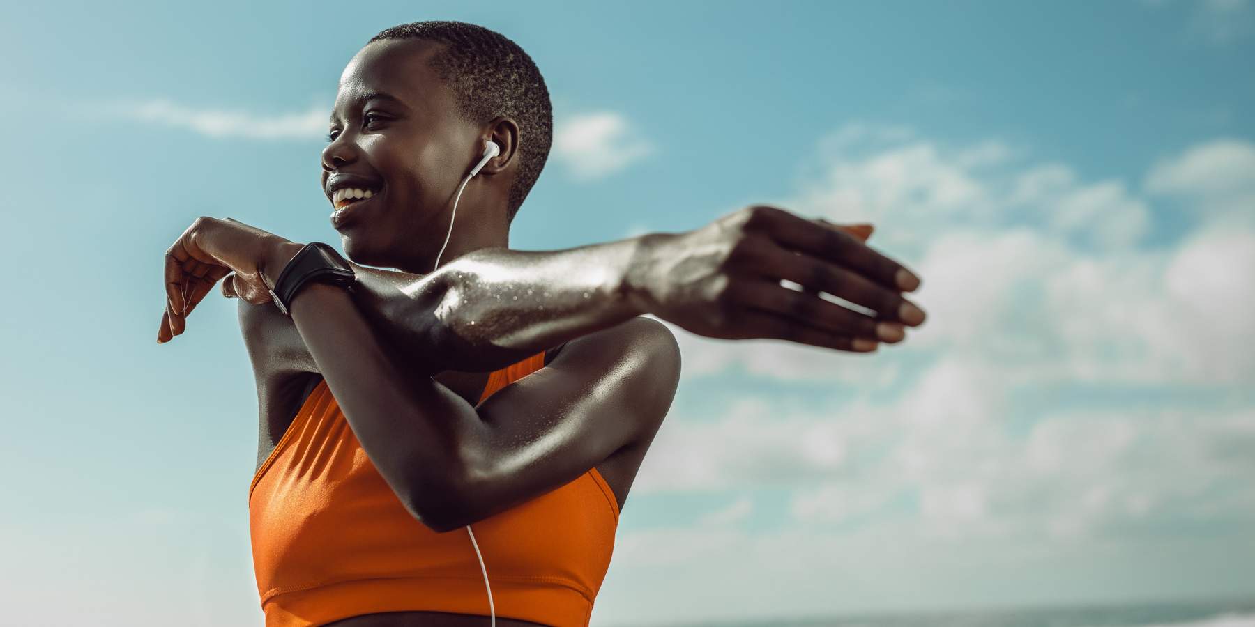 Black woman stretching at the beach during a morning workout during The Great Lock In reset