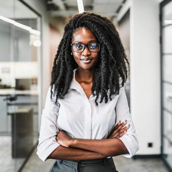 Cheerful-Black-career-woman-posing-in-office