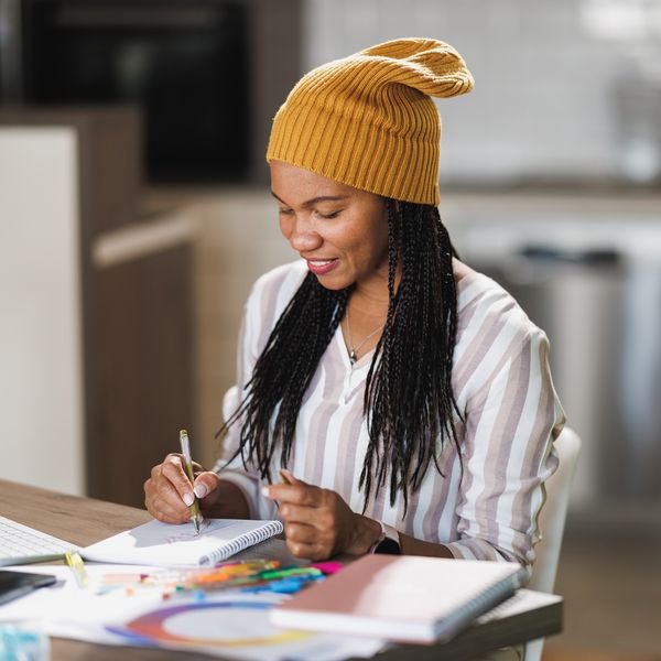 Cheerful-Black-woman-coloring-for-self-care