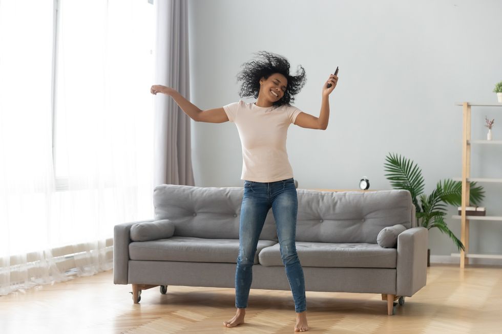 Cheerful-woman-dancing-in-her-living-room