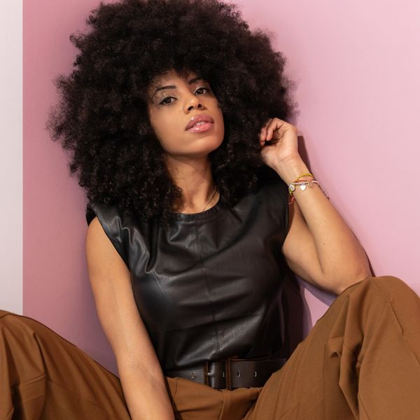 Close-up of a woman with healthy, long natural hair, embracing her hair growth journey