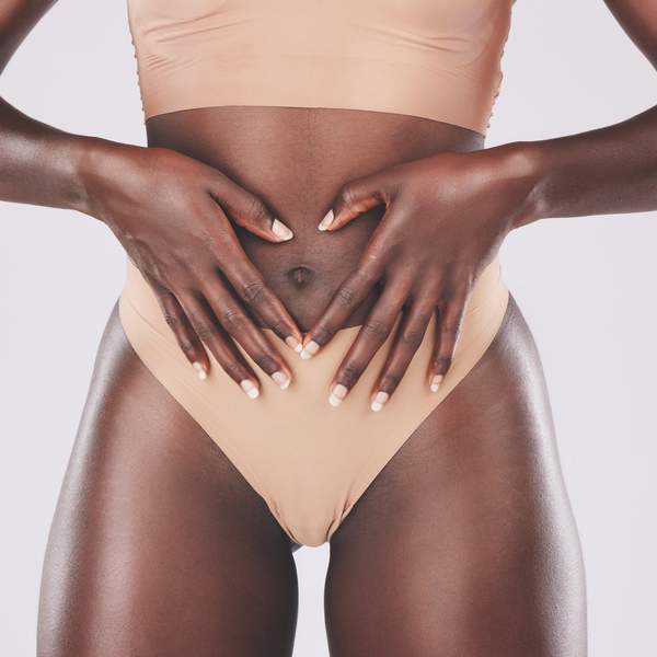 Close-up-of-woman-in-her-underwear-with-her-hands-in-front-of-her-womb-in-a-heart-shape