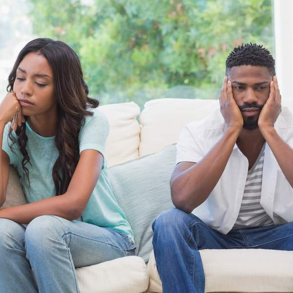Couple having argument on the couch at home in the living room