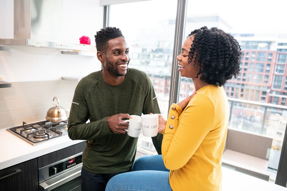 Couple-having-coffee-in-the-kitchen-in-the-morning