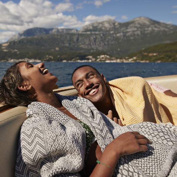 couple-laughing-on-a-boat-on-a-lake