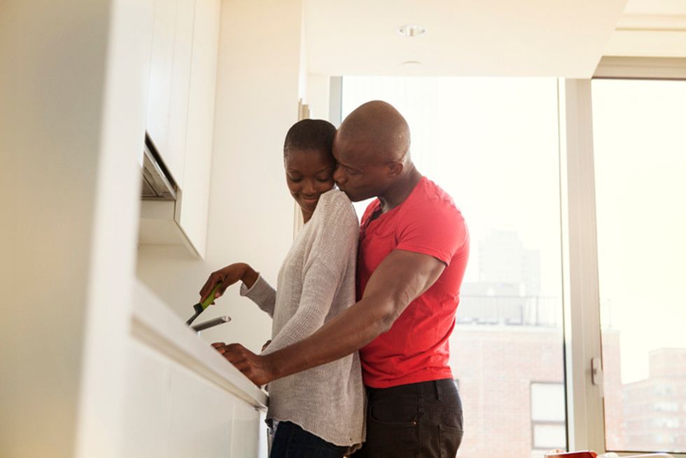 Couple-sharing-loving-embrace-in-kitchen