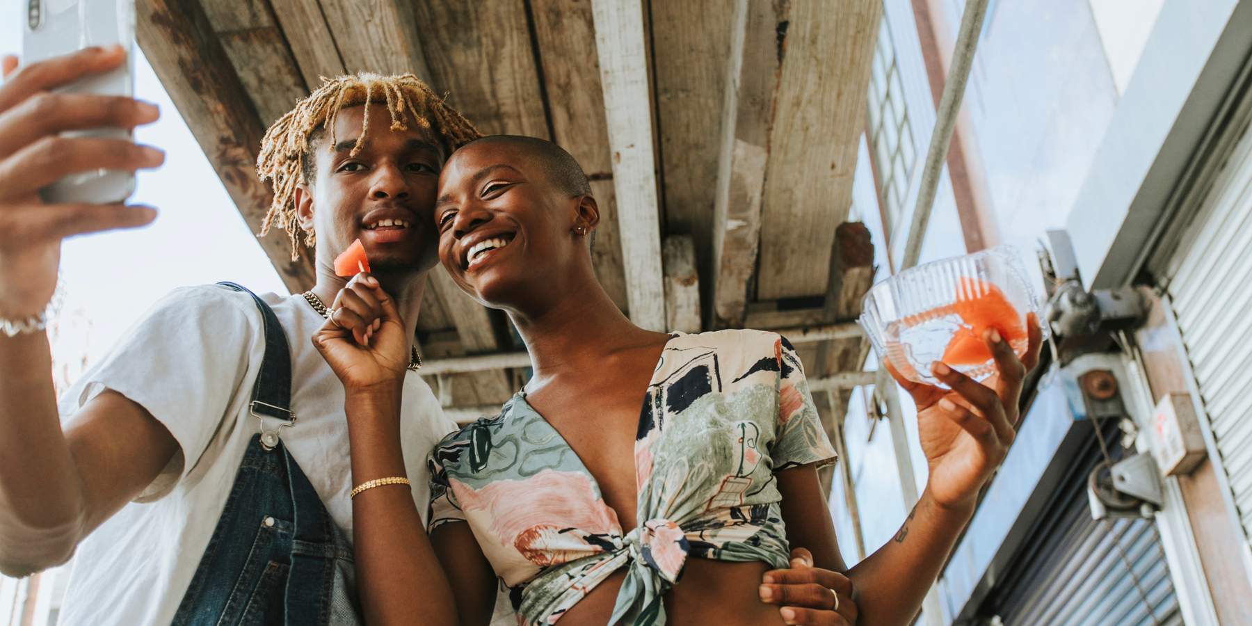 Couple snacking on fruit in the summer