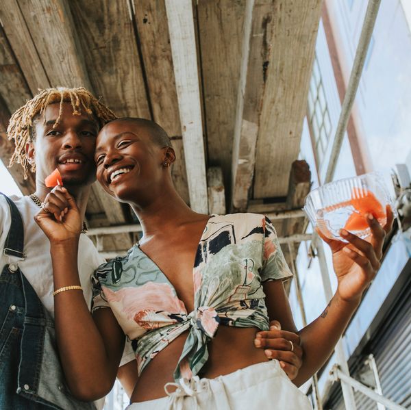 Couple snacking on fruit in the summer