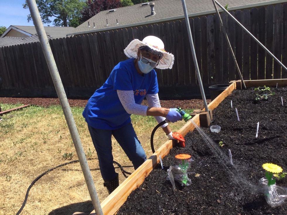 GirlTrekker Watering Her Garden