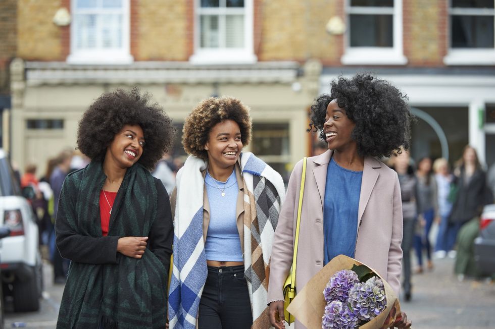 group-of-friends-walking-talking-down-the-street