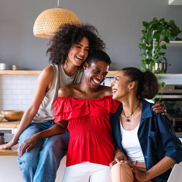 Happy beautiful hispanic south american and black women meeting indoors and having fun - Black adult females best friends spending time together, concepts about domestic life, leisure and friendship