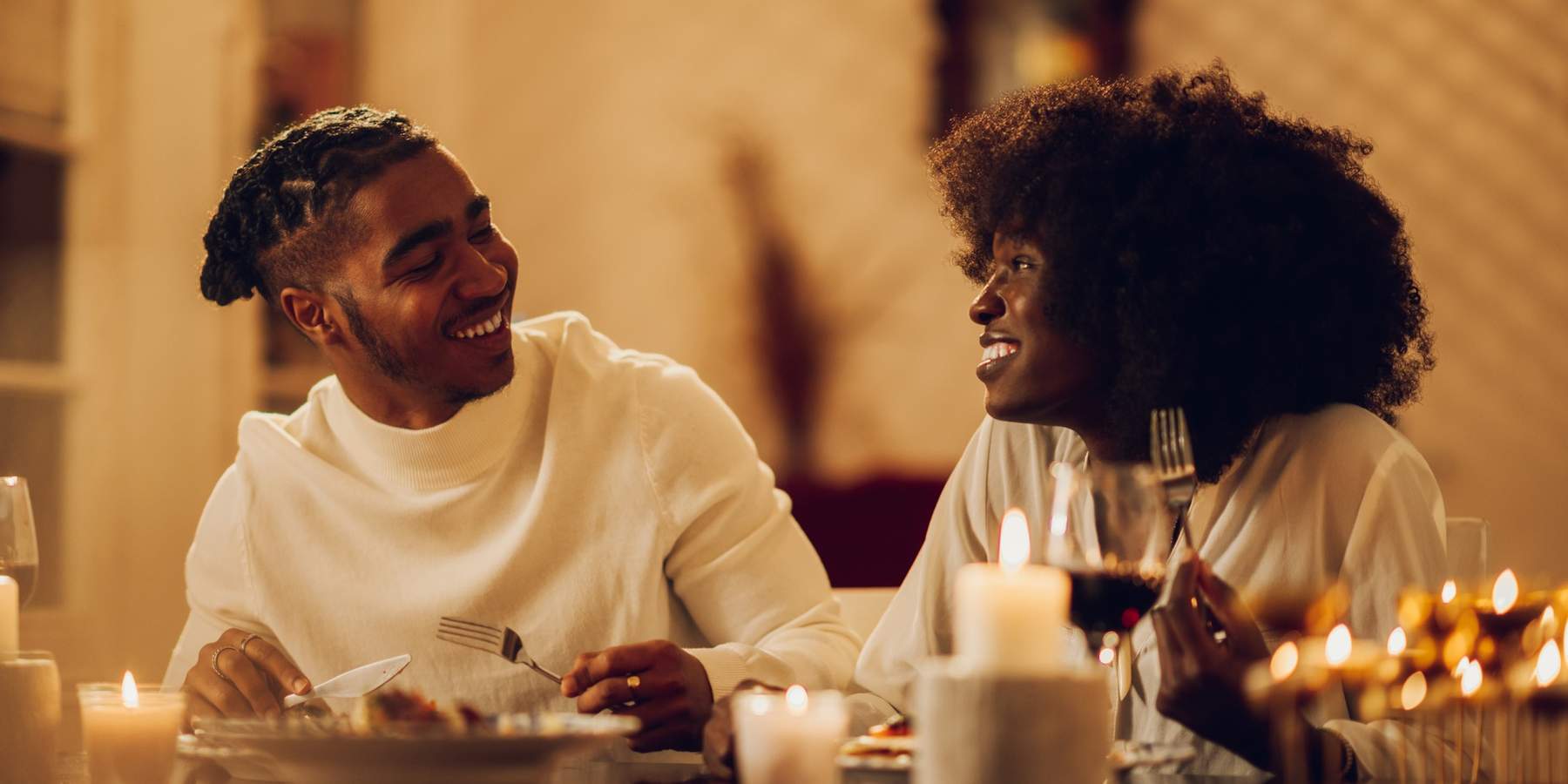happy-young-Black-couple-having-romantic-dinner-date-night-at-home-by-candlelight