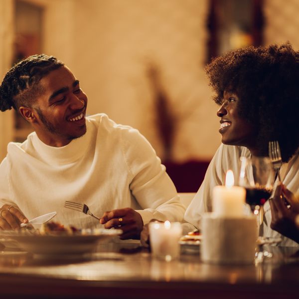 happy-young-Black-couple-having-romantic-dinner-date-night-at-home-by-candlelight