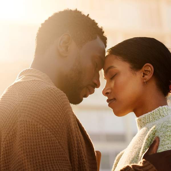 Heterosexual-Black-couple-melting-in-a-loving-embrace-touching-foreheads-with-their-eyes-closed