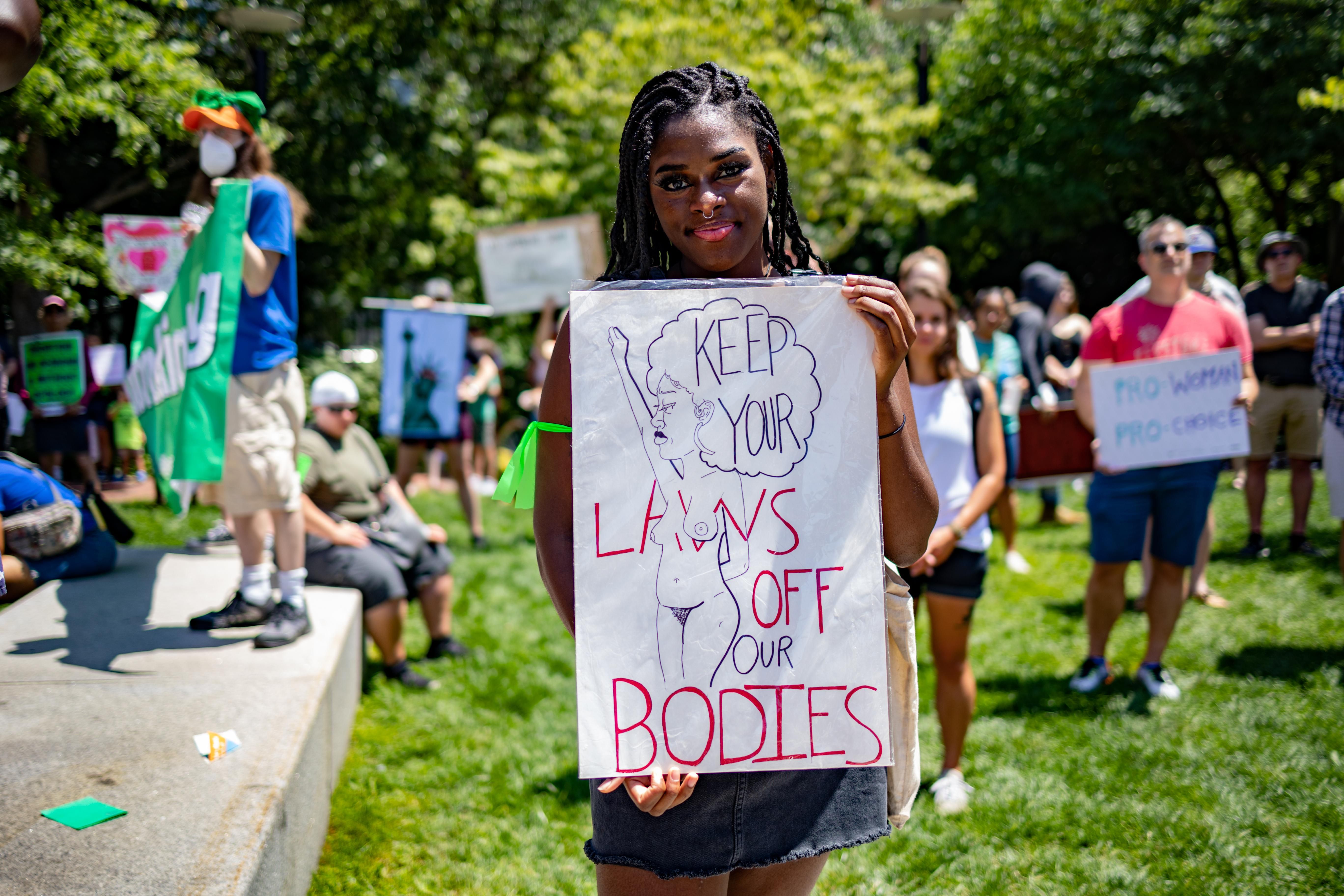 a-black-woman-protester-holding-up-a-sign-during-abortion-protest