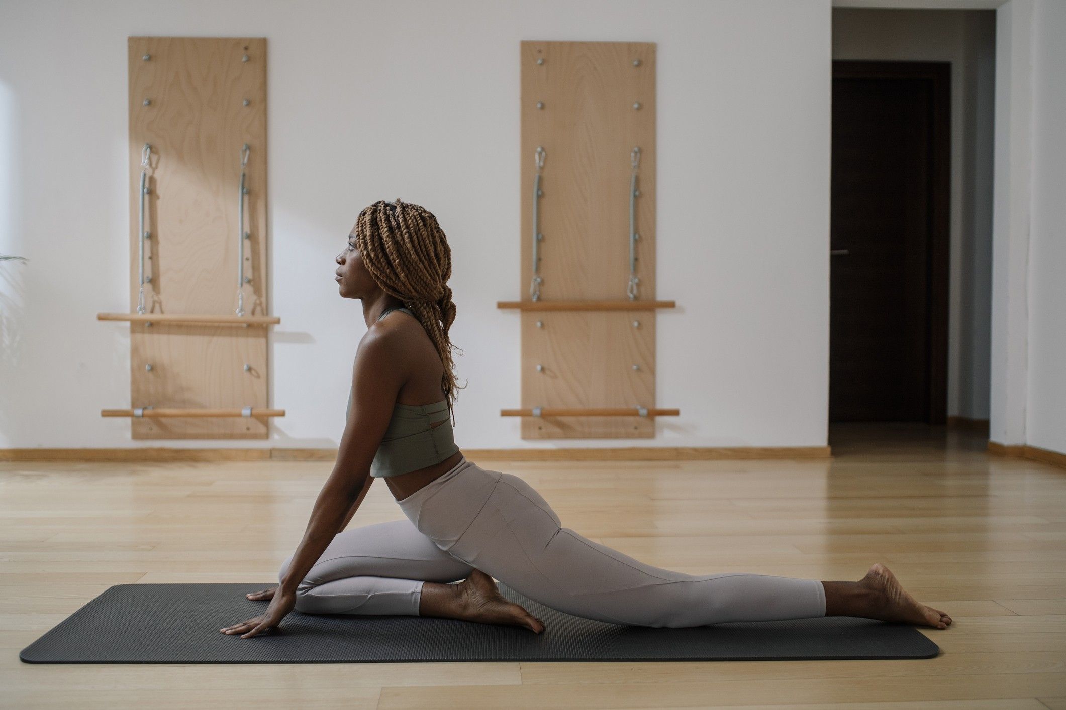 Black-woman-in-exercise-clothes-doing-Pilates-beginner