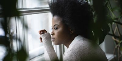 Black-woman-looking-out-of-her-window-searching-for-something-purpose