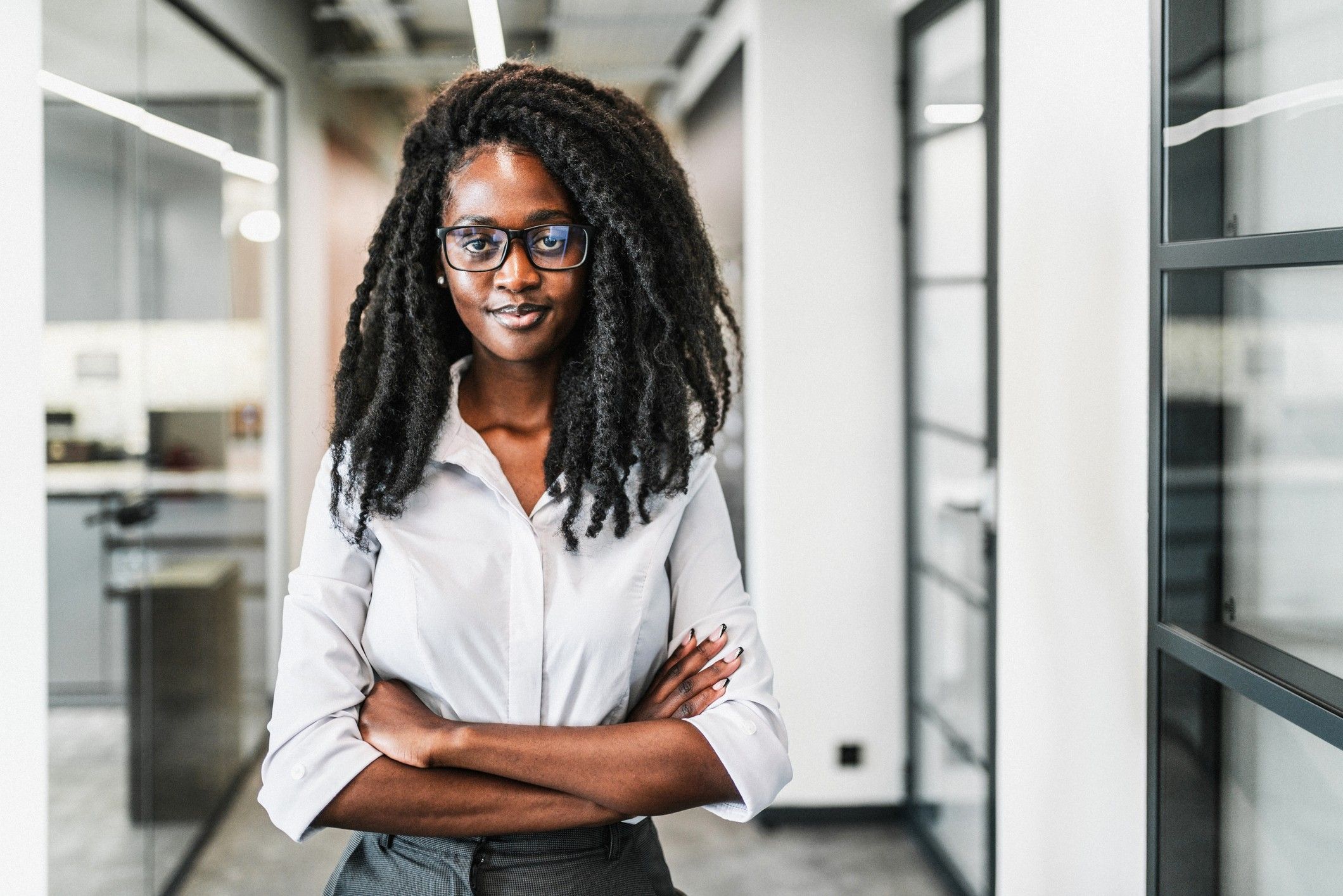 Cheerful-Black-career-woman-posing-in-office