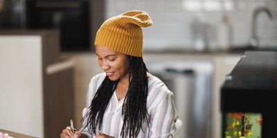 Cheerful-Black-woman-coloring-for-self-care