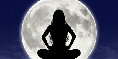Silhouette-of-young-woman-in-meditation-pose-full-moon-in-virgo-in-the-background