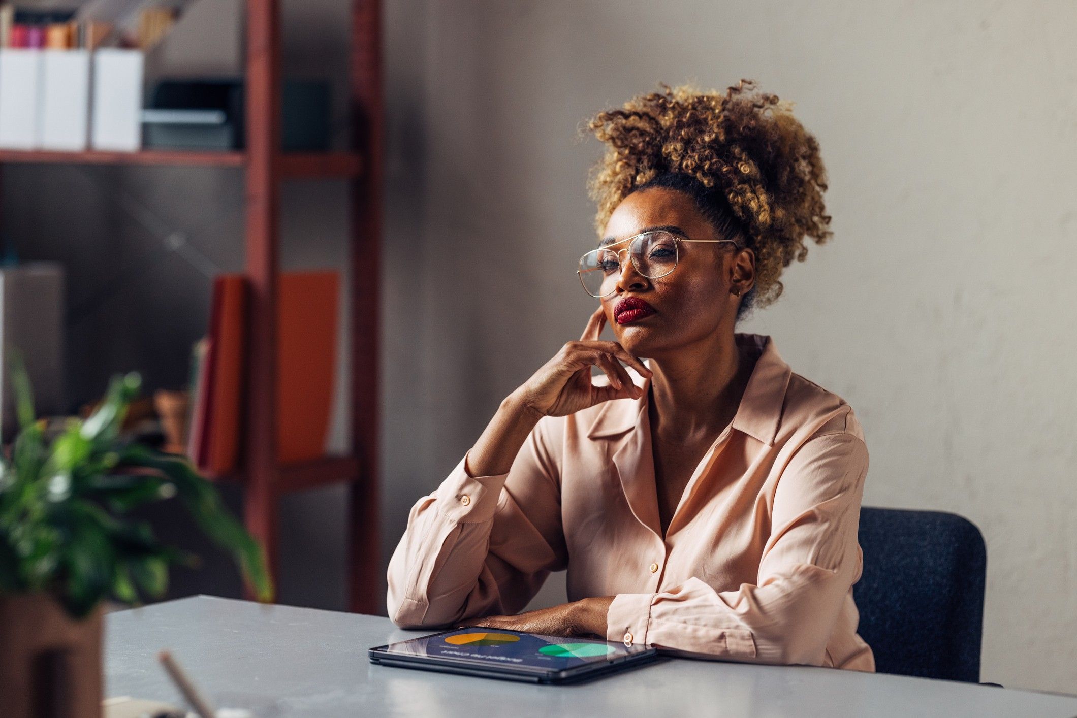 Quiet-Black-woman-deep-in-serious-thought-thinking-in-the-workplace