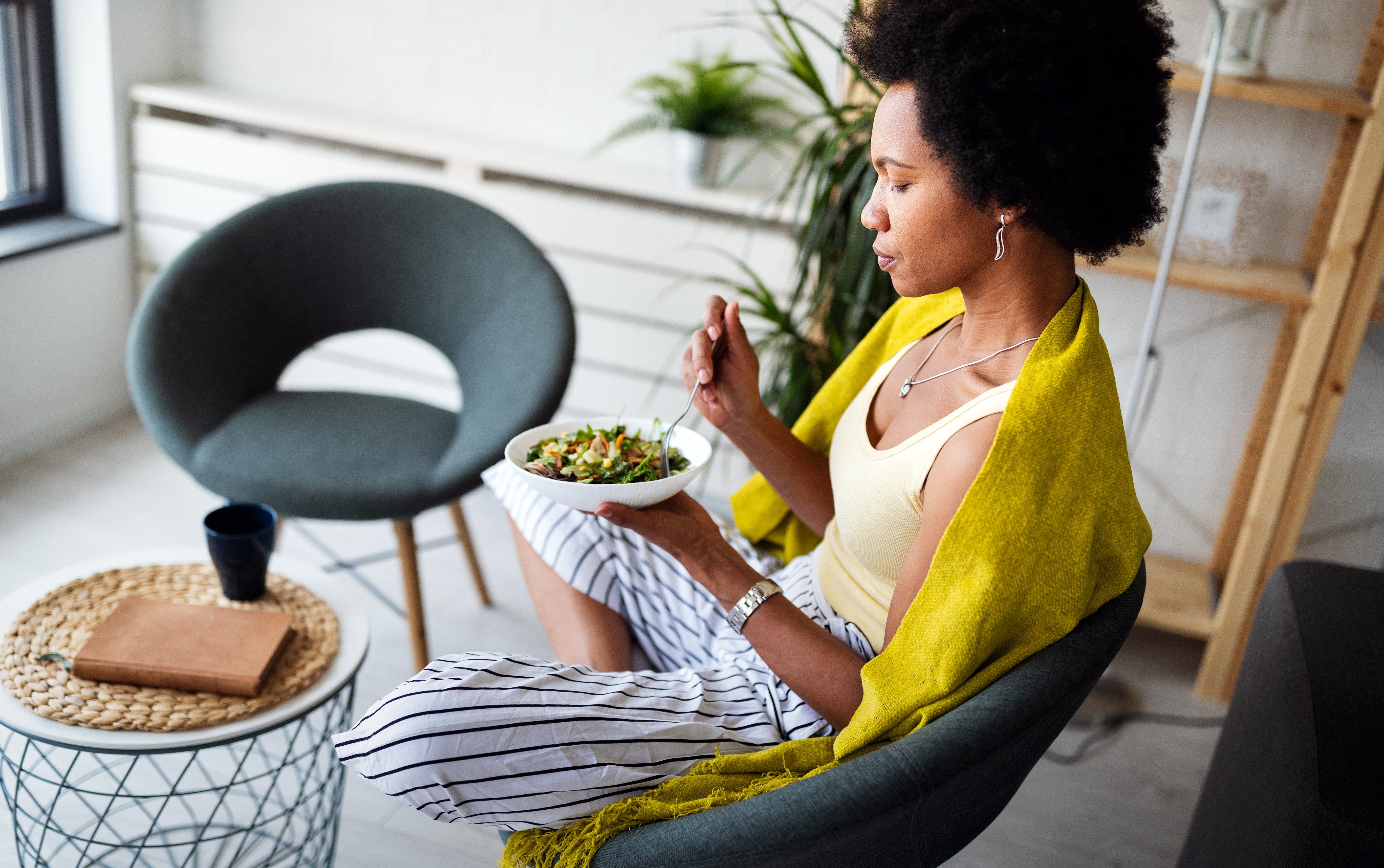 Beautiful woman eating healthy fresh organic salad