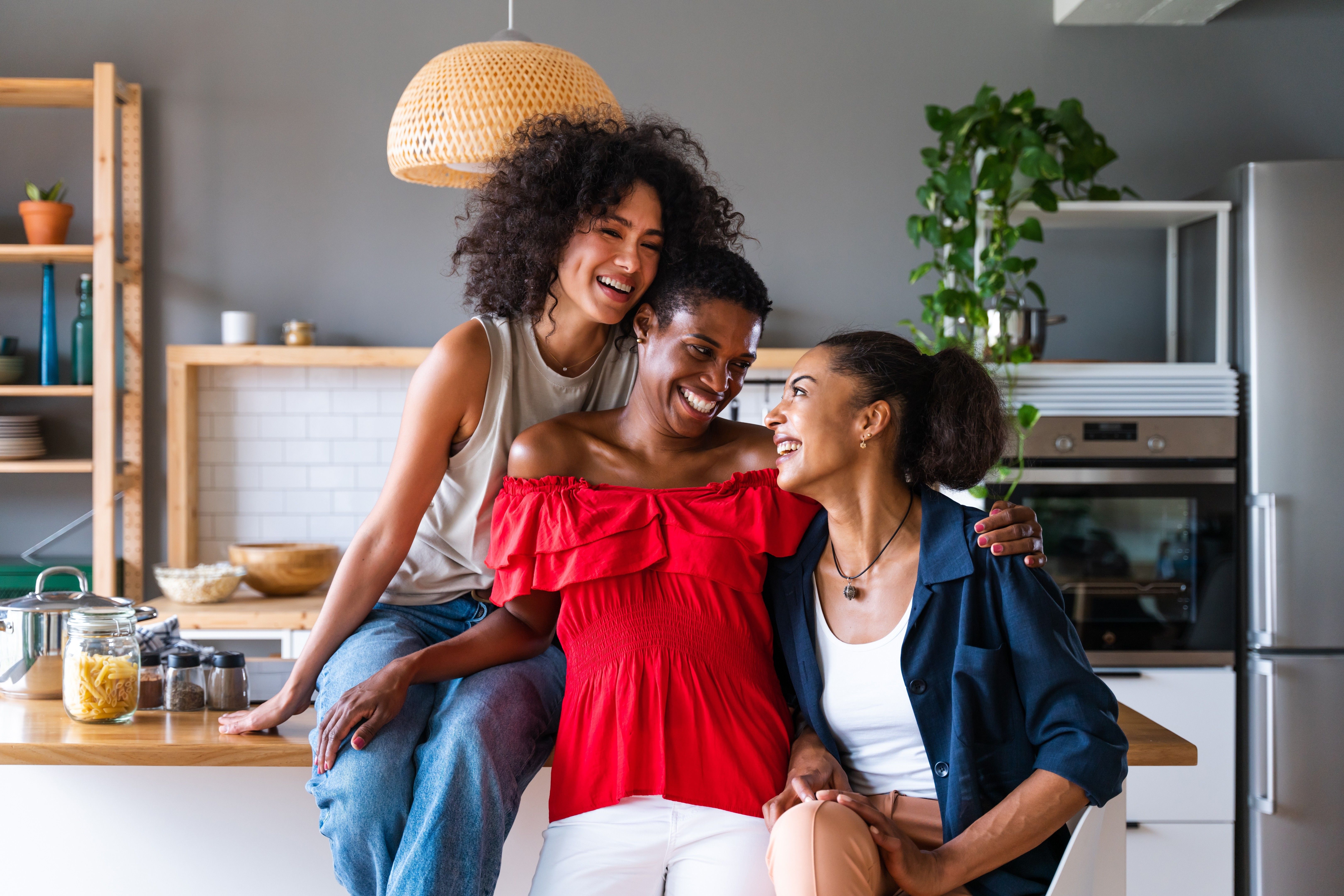 Happy beautiful hispanic south american and black women meeting indoors and having fun - Black adult females best friends spending time together, concepts about domestic life, leisure and friendship