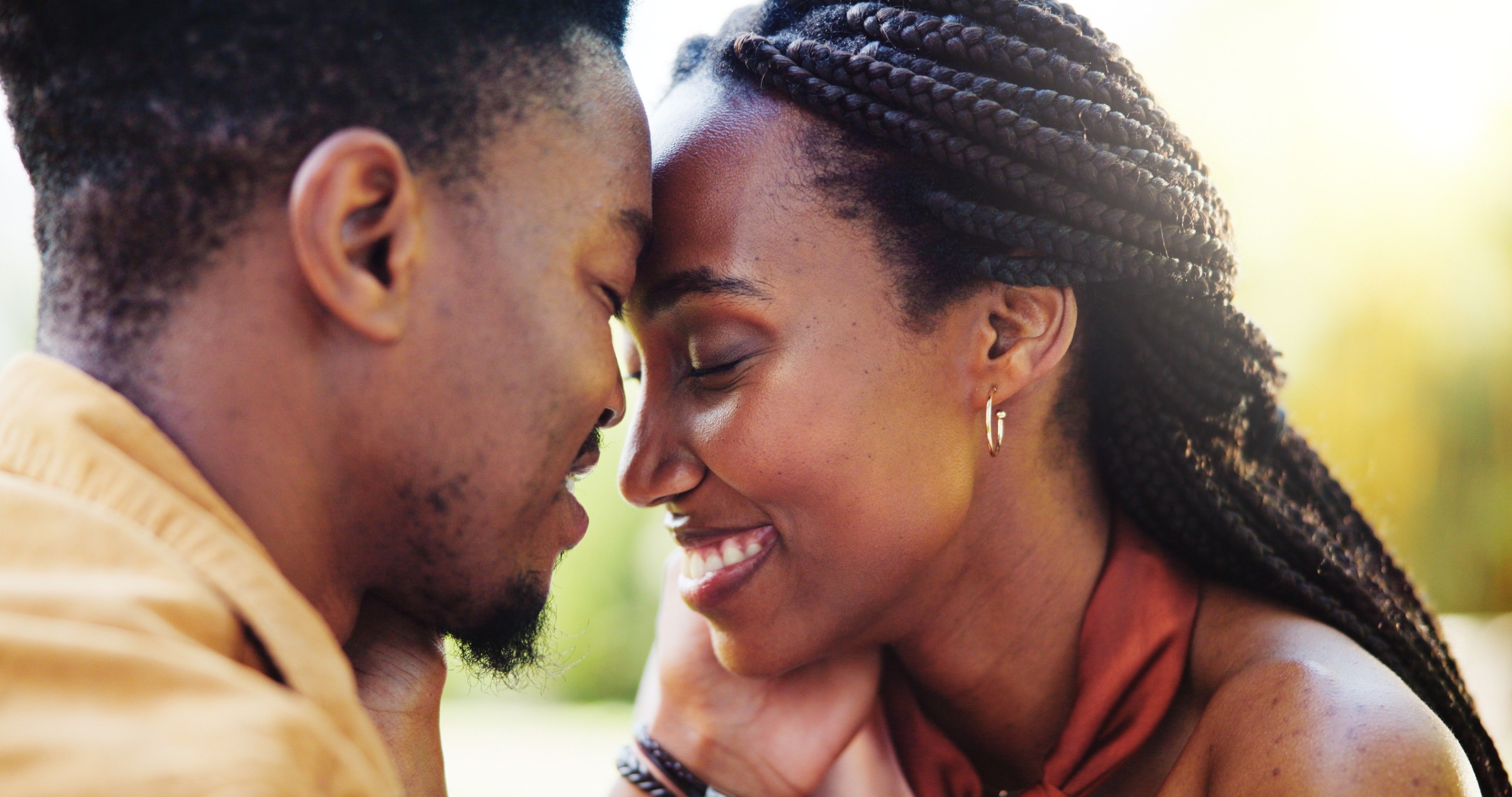Love, forehead touch and black couple in park together for bonding, relationship and affection in nature. Relax, dating and happy man and woman outdoors for romance, embrace and commitment on weekend