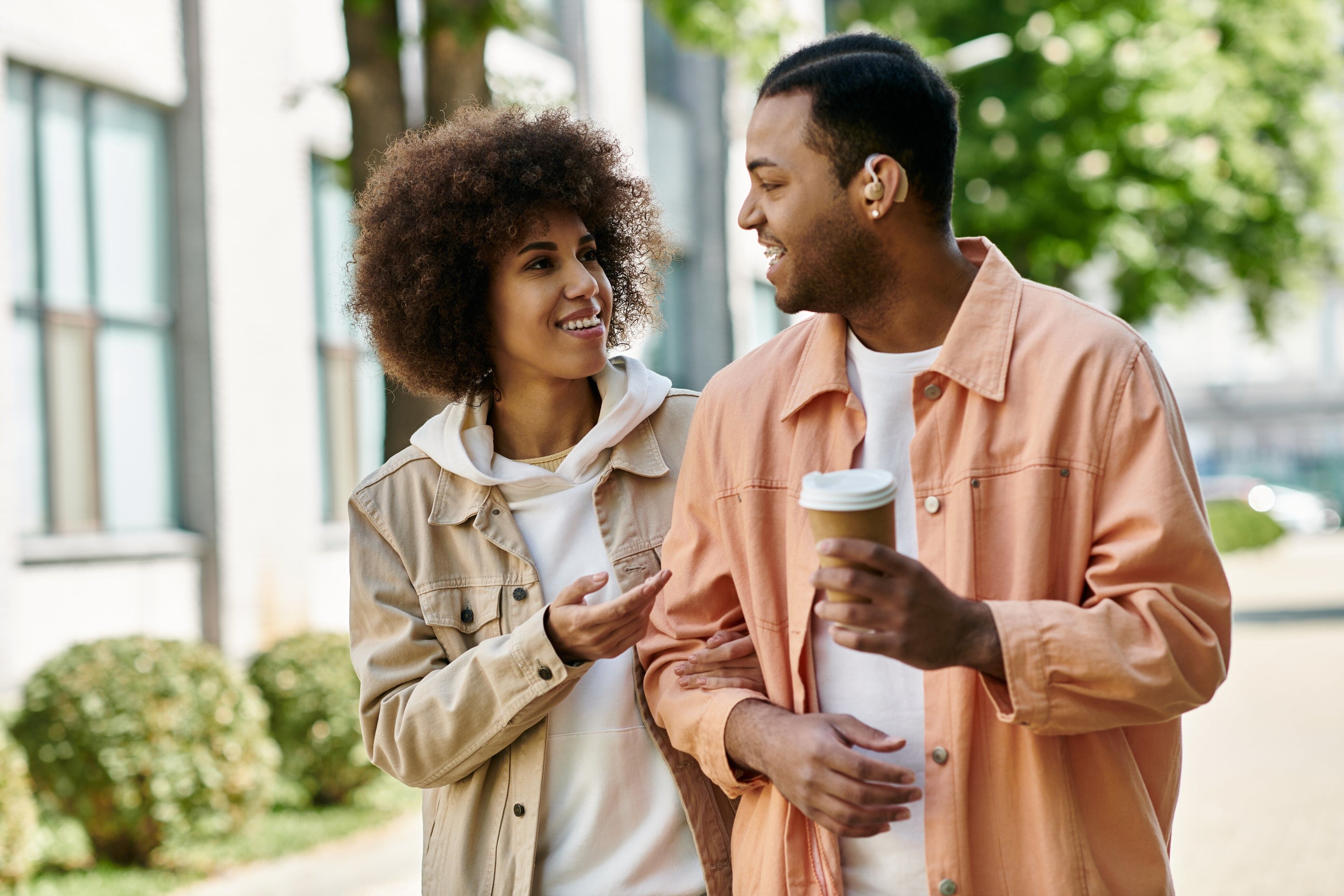 Two friends walking close and laughing, hinting at possible romantic chemistry